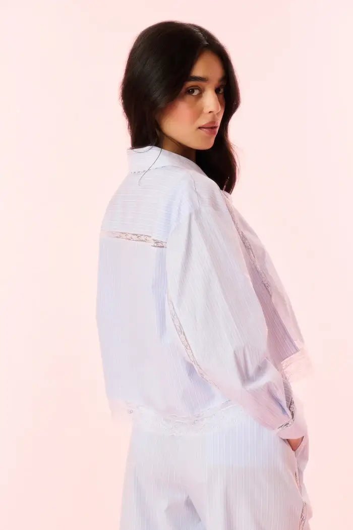 The feminine blouse hits at the natural waist and features the pretty laces on the body and sleeves.