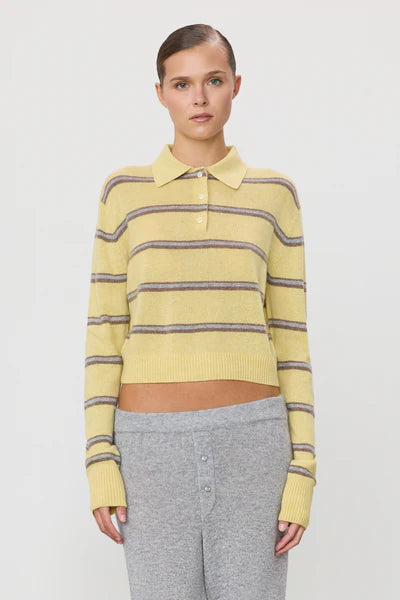 woman wearing butter yellow stiped polo sweater
