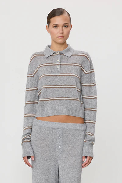 Woman wearing grey striped polo cashmere sweater