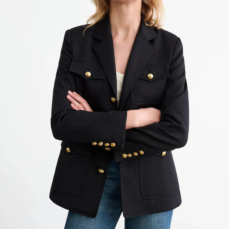 Soft structured shoulder pads. Chest flap patch pockets. Flap patch pockets. Signature crest buttons in gold at front and sleeve. Seaming details for shape. Interior chest pocket. Back vent. Fully lined.