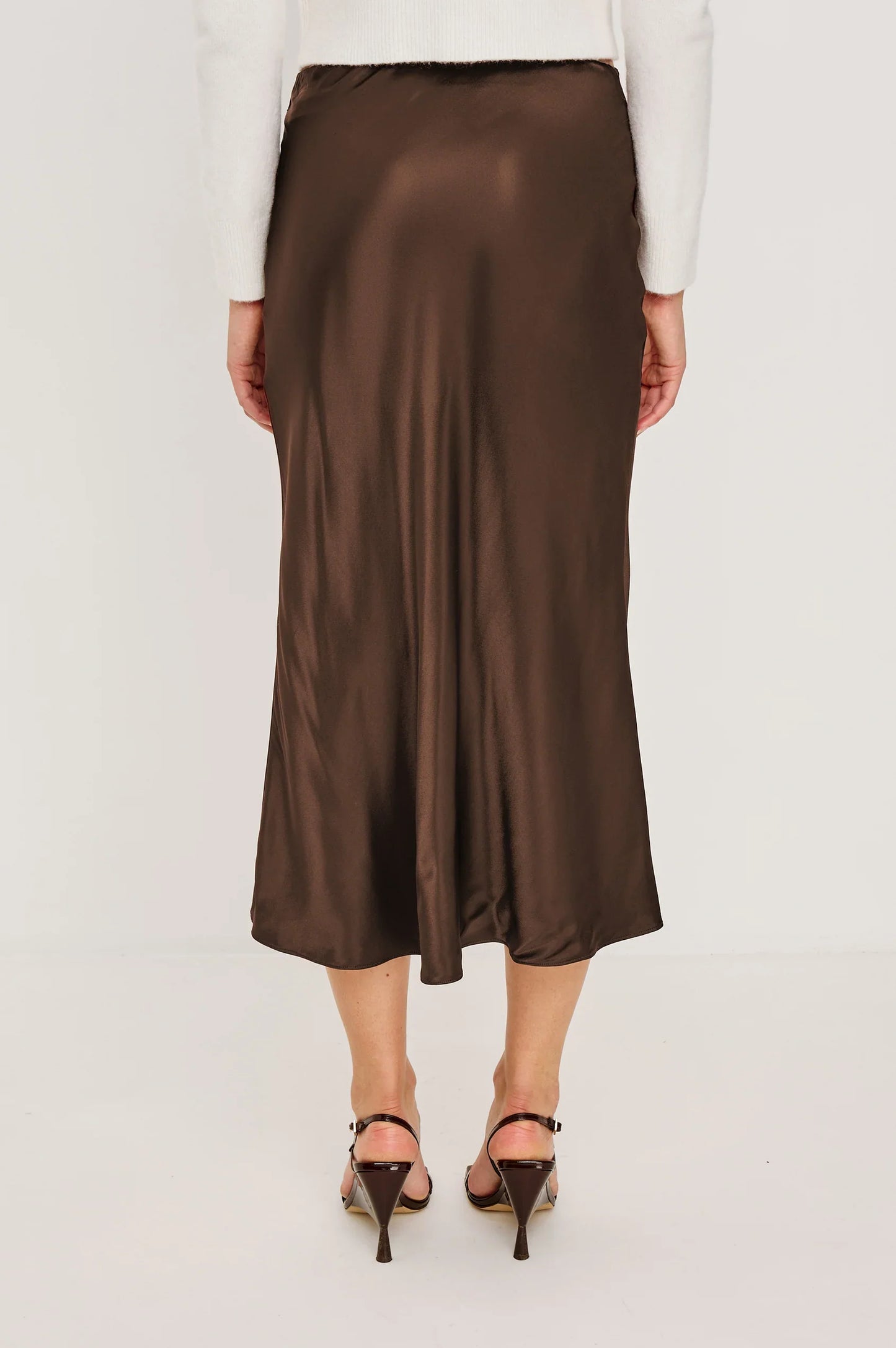 Brown satin skirt worn by a person on a white background
