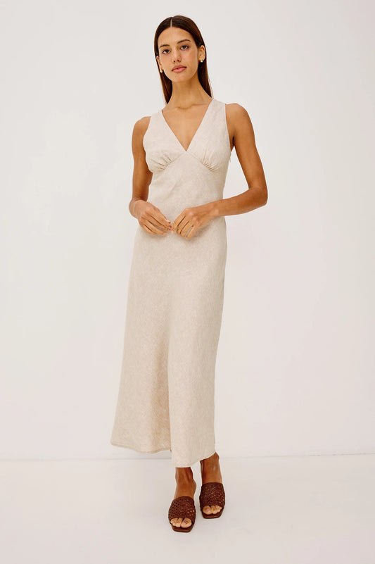 The Avianna is a sleeveless, bias-cut midi dress in softly structured linen with a plunging V-neckline