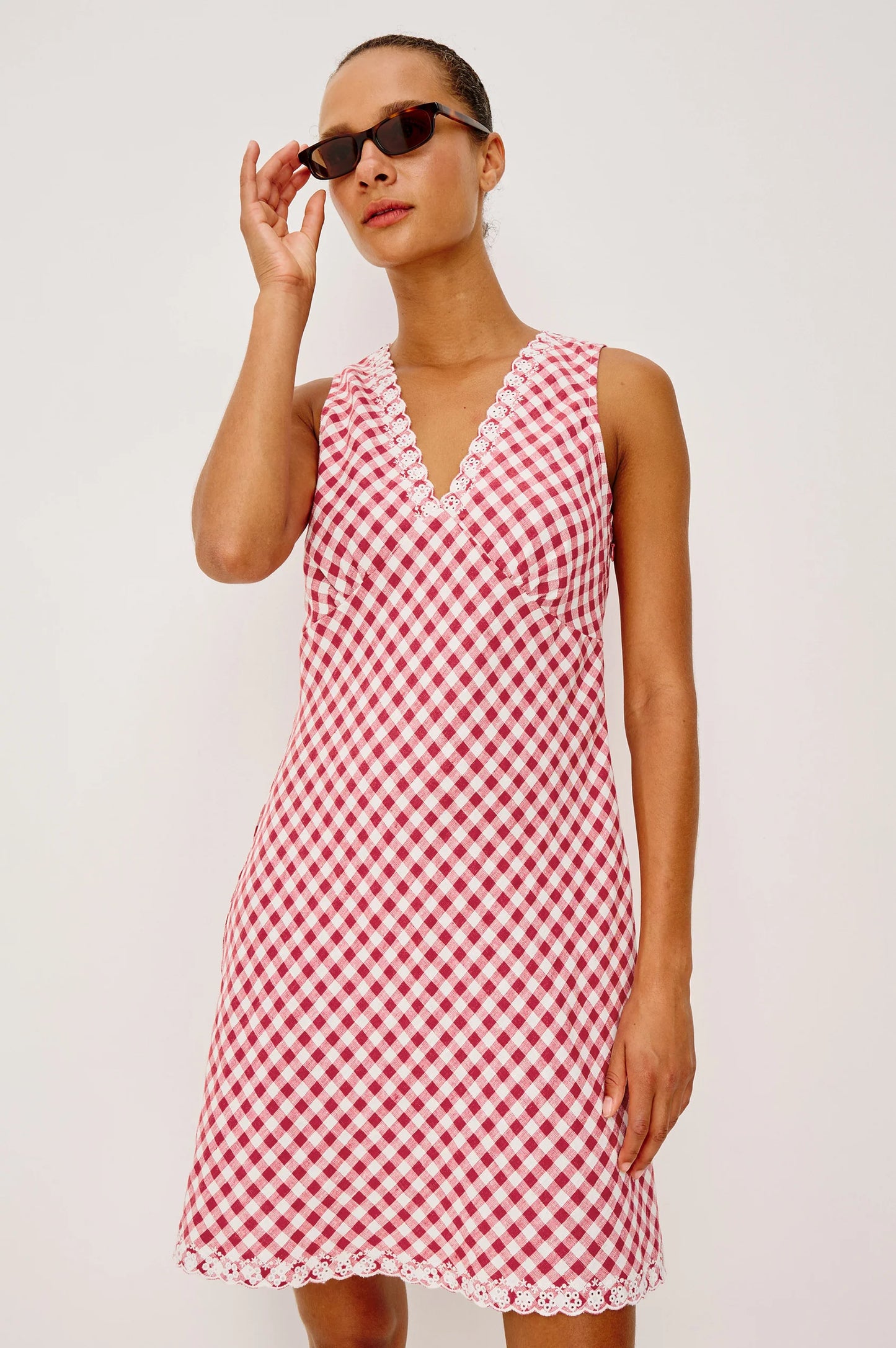 The Bex is a luxe linen mini dress cut on the bias with an embroidered V-neckline and hem, side-seam zip, and A-line skirt.