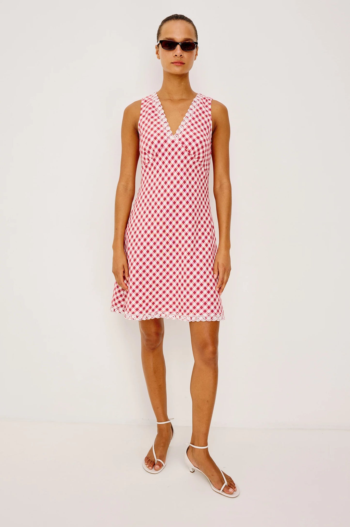 The Bex is a luxe linen mini dress cut on the bias with an embroidered V-neckline and hem, side-seam zip, and A-line skirt.