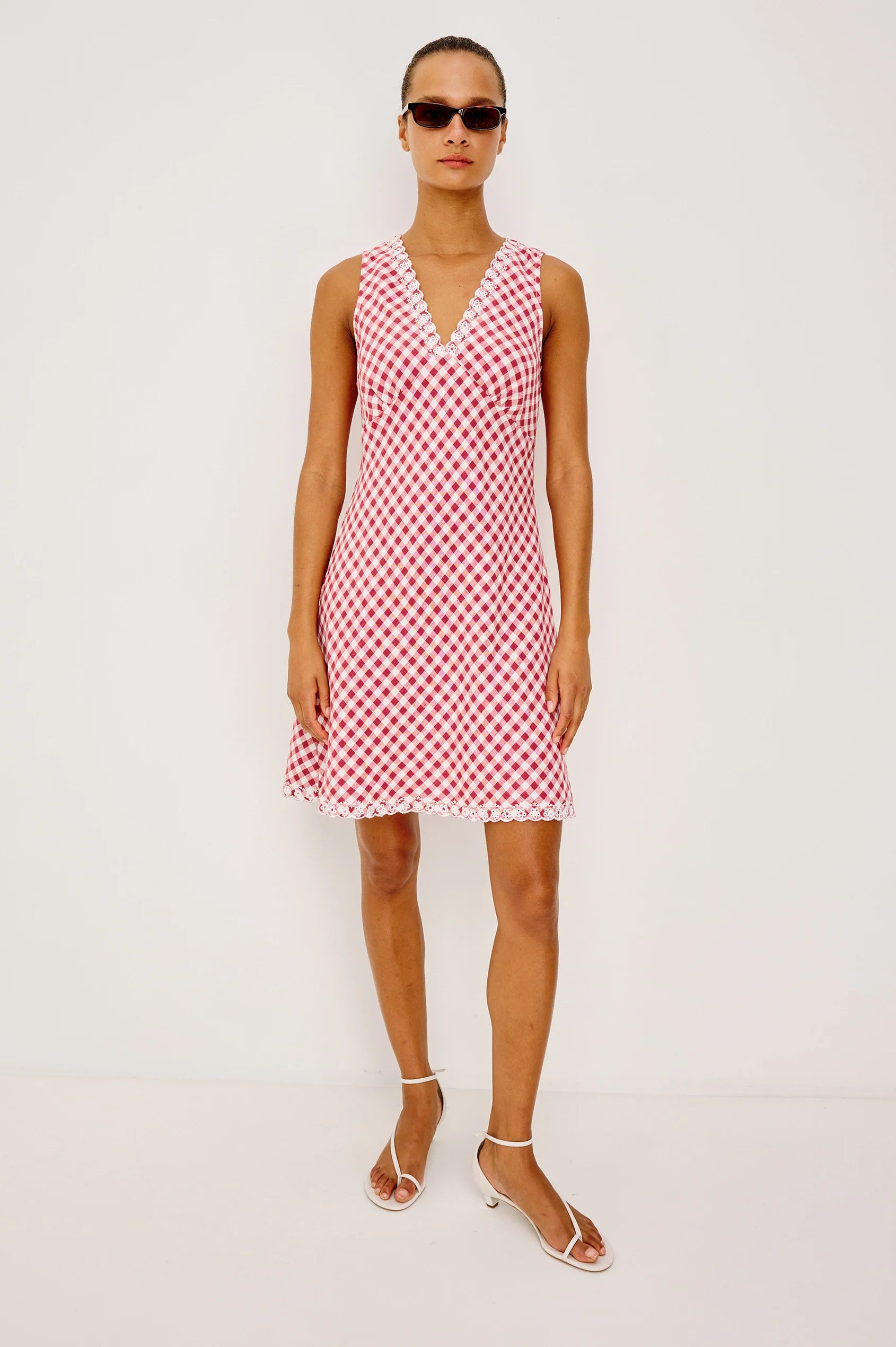 The Bex is a luxe linen mini dress cut on the bias with an embroidered V-neckline and hem, side-seam zip, and A-line skirt.