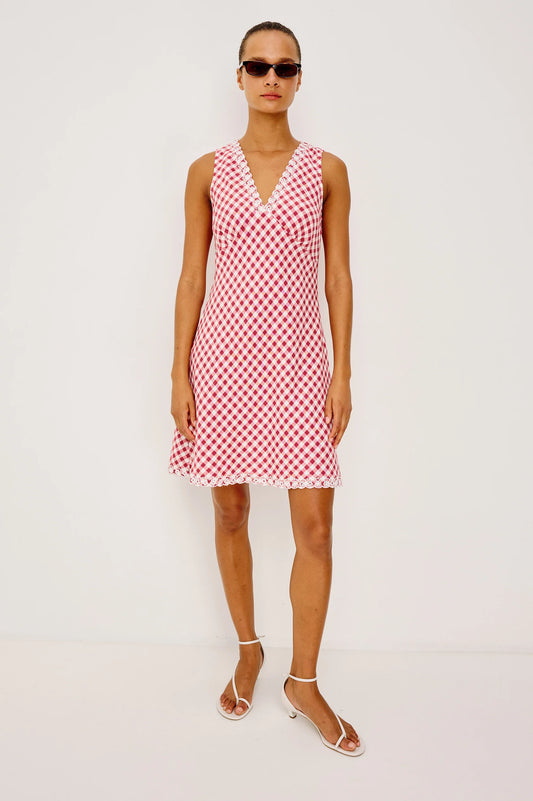 The Bex is a luxe linen mini dress cut on the bias with an embroidered V-neckline and hem, side-seam zip, and A-line skirt.