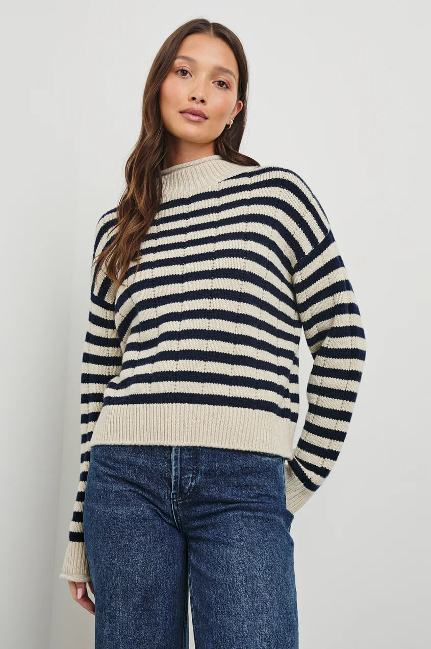 A heritage-inspired sweater crafted from ultra-soft, merino wool. With novelty drop-stitch and cast-off details at the cuffs and roll-neck