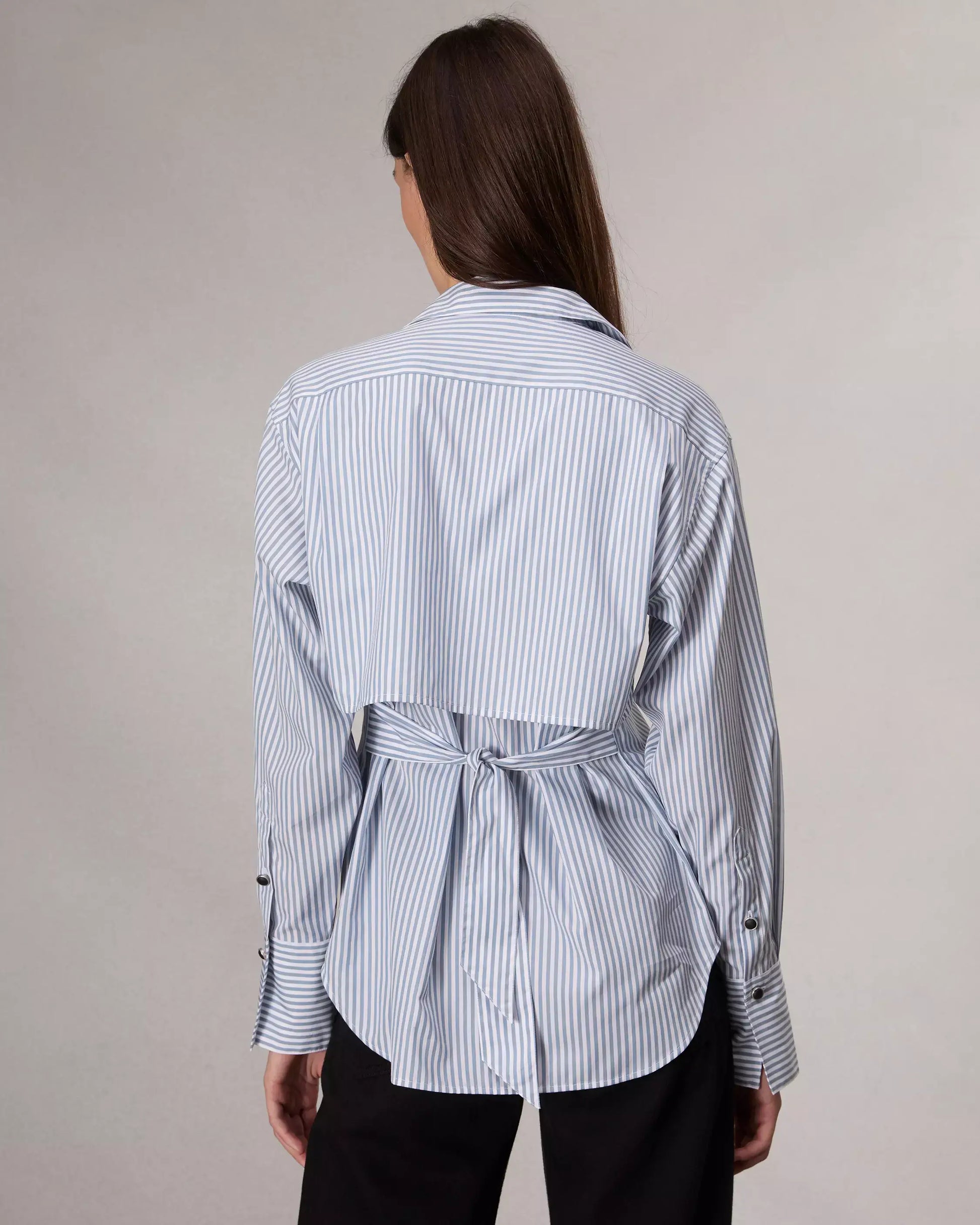 Tailored from crisp cotton poplin, this striped button-up shirt nods to classic trench coats with a storm shield-inspired panel and adjustable waist tie at the back.