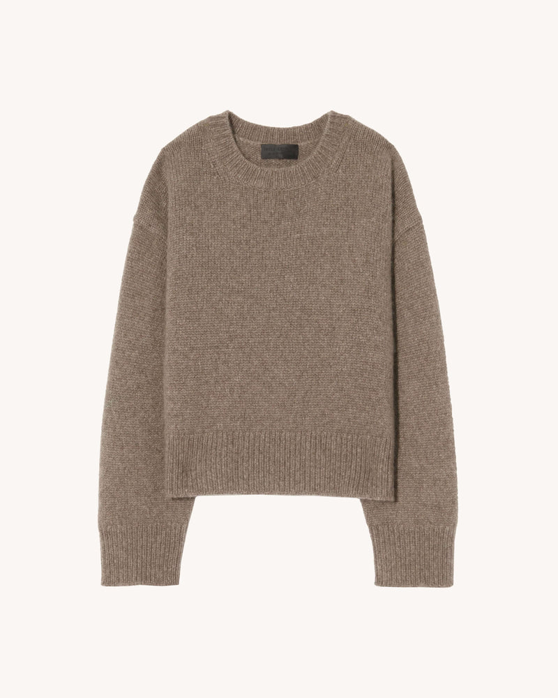 Chunky weight, oversized boxy sweater in Italian air spun cashmere. Regular body and sleeve length. Dropped shoulder. Rib start at hem and sleeve. Single layer rib at neck. Fashioning along arm hole. Signature center back cable knit detail.