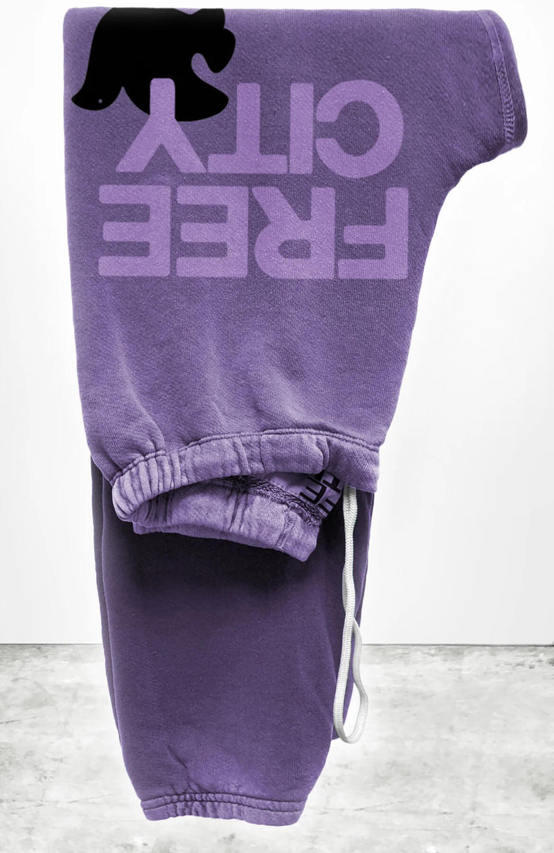 Unisex FLOW sweatpant in lavender petal with classic "FREECITY" print in lilac and black "FREECITYDOVE," covered elastic waist and pull drawcord.