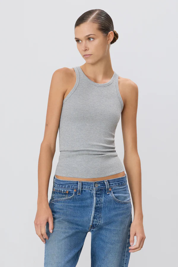 Woman wearing grey high neck fitted ribbed tank and jeans