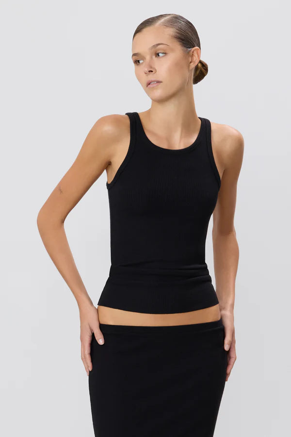 Woman wearing black ribbed high neck fitted tank