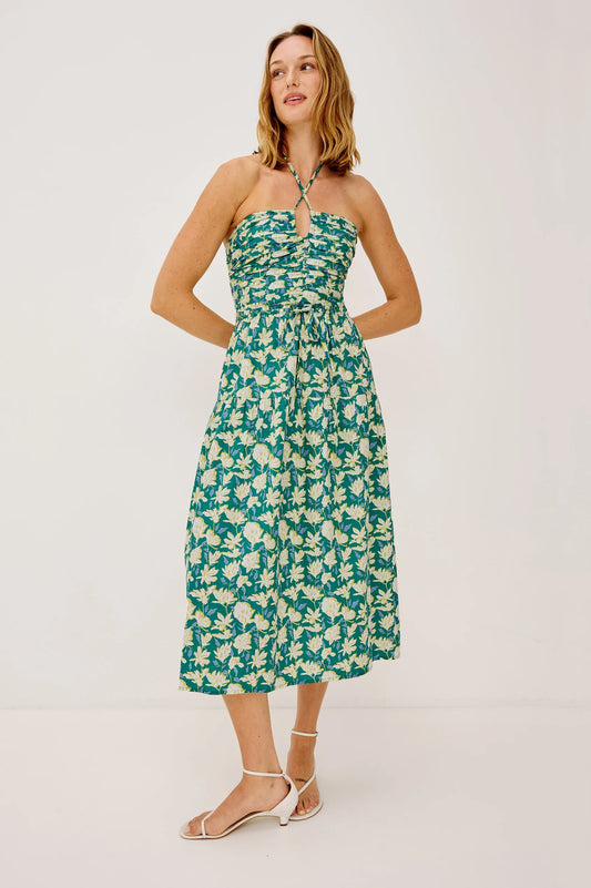 The Irene is an artful and effortless midi dress, featuring a ruched, semi-sheer keyhole bodice with adjustable halter ties