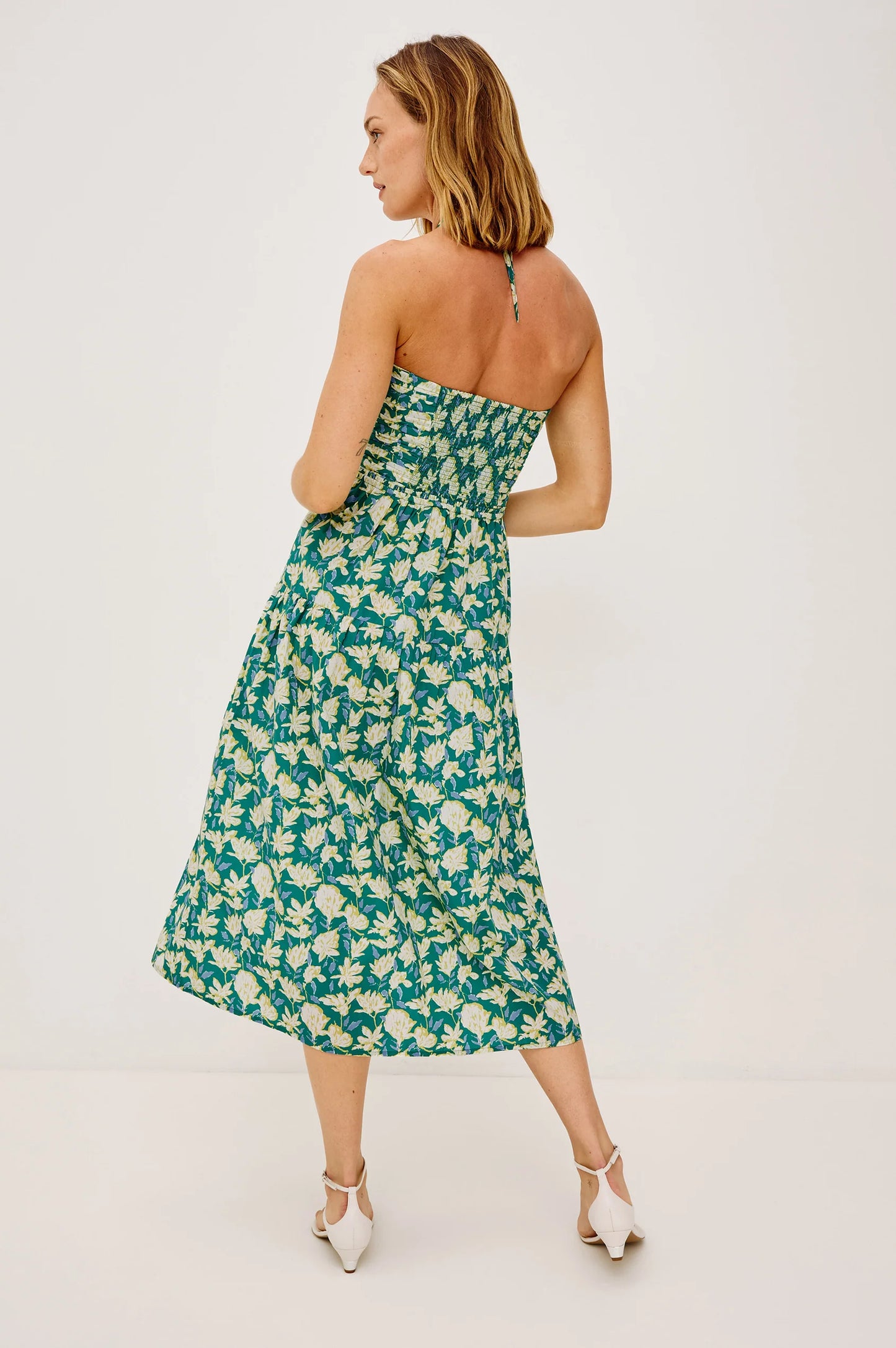 The Irene is an artful and effortless midi dress, featuring a ruched, semi-sheer keyhole bodice with adjustable halter ties