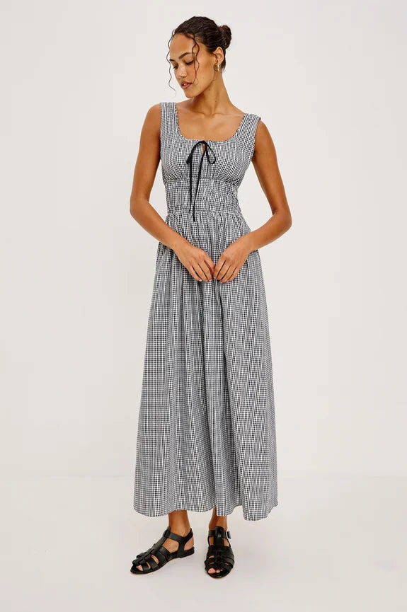 Woman wearing bblack and white gingham dress with bow tie 