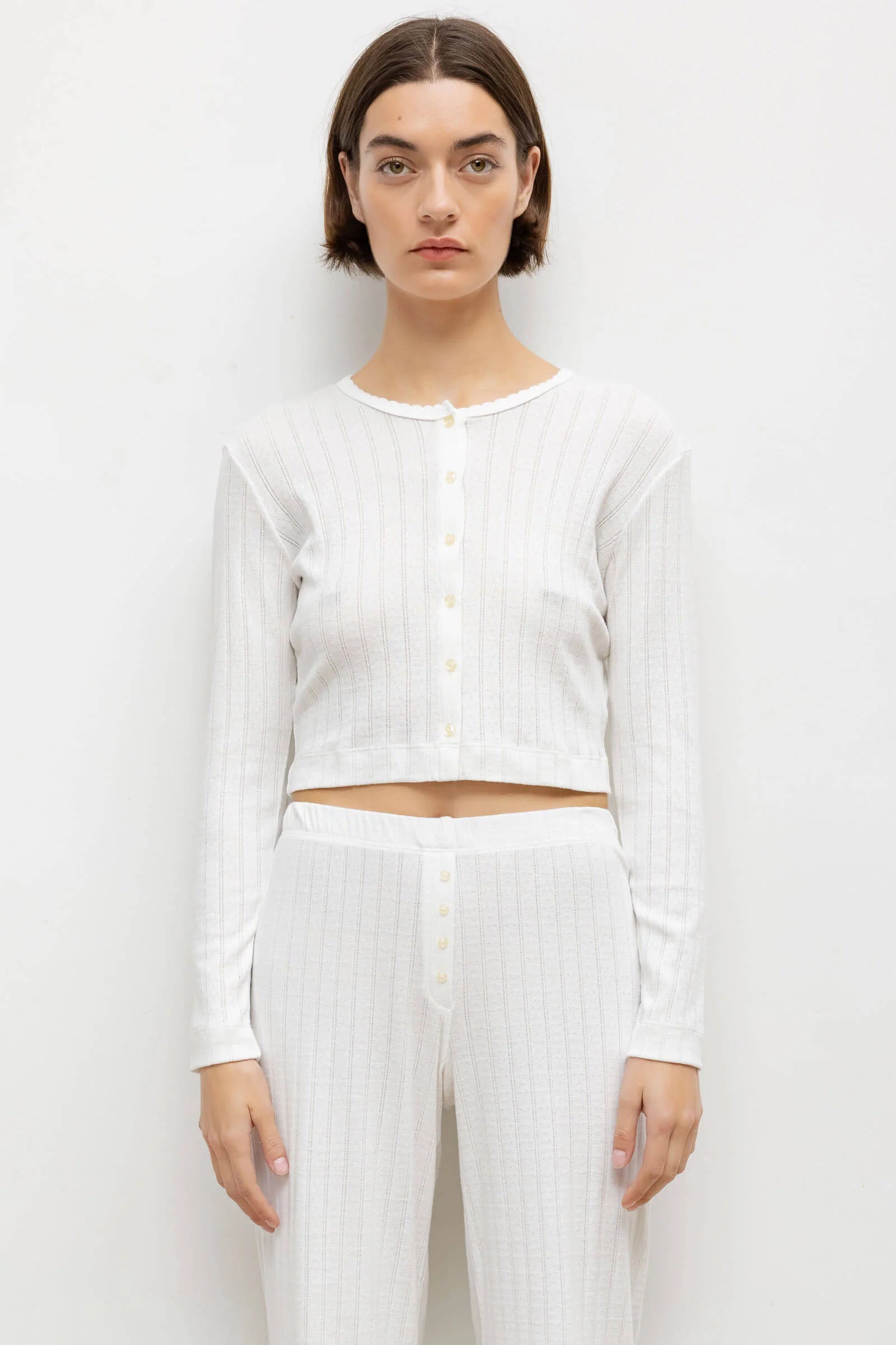 LESET Pointelle Crop Cardigan in White, featuring delicate pinhole stripes, scalloped trim and button-front styling with matching pointelle pants.