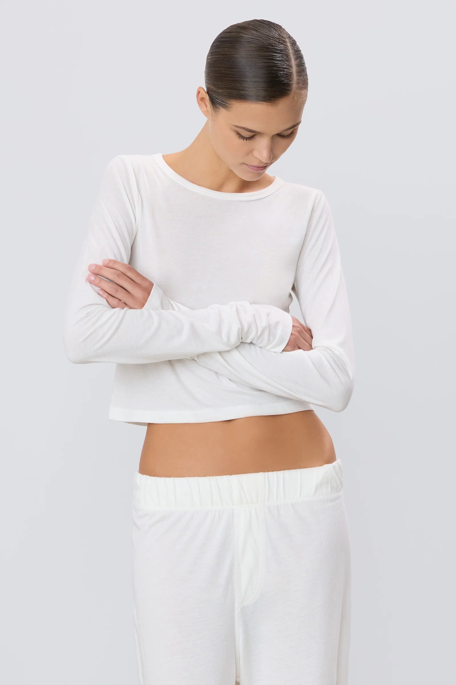 Woman wearing white ivory long sleeve cropped tee