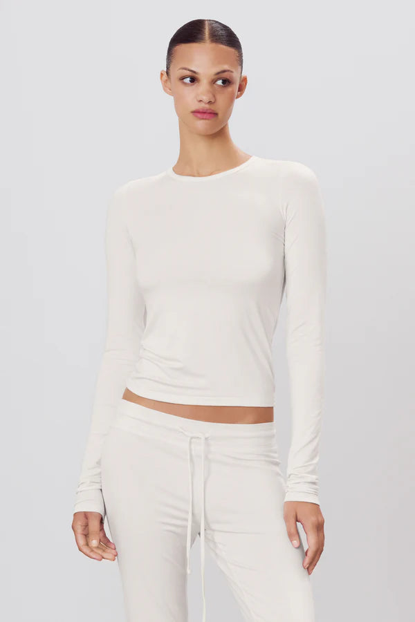 woman wearing ivory long sleeve fitted top 