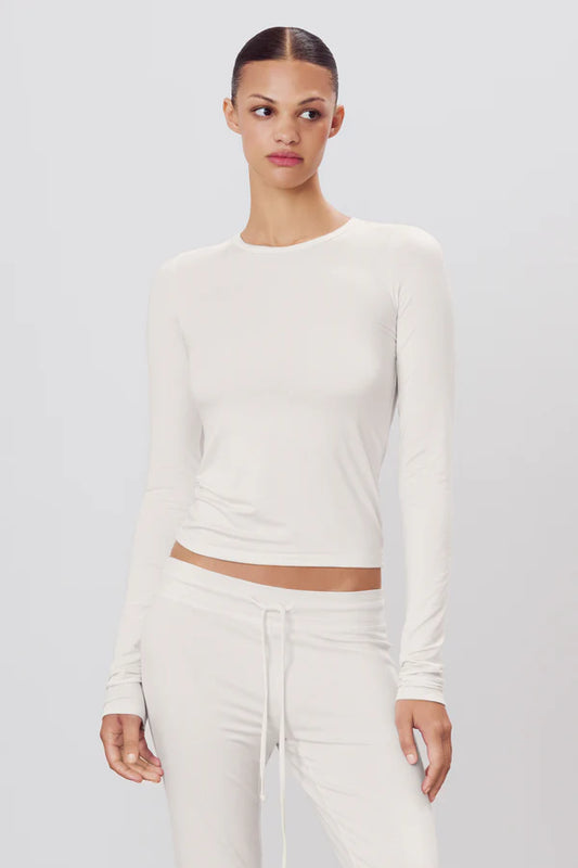 woman wearing ivory long sleeve fitted top 