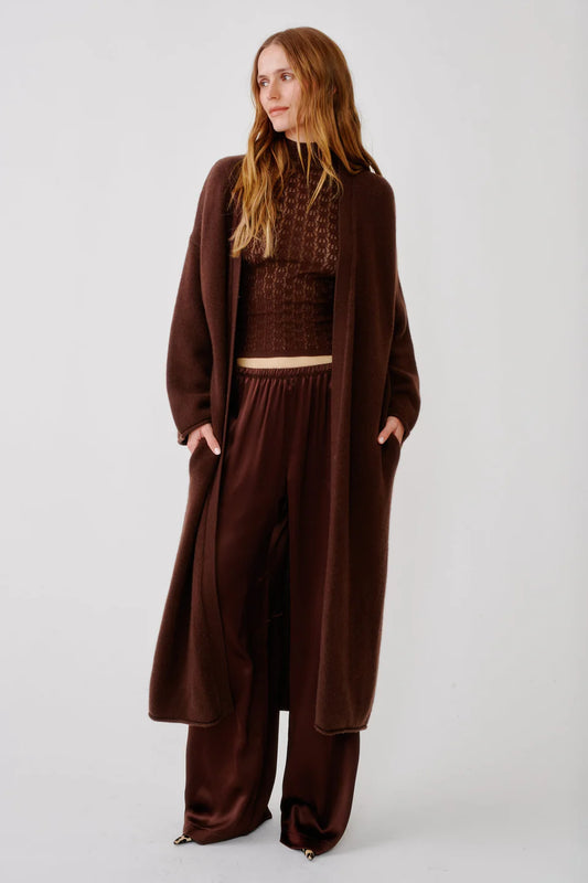 woman wearing al brown outfit with long duster