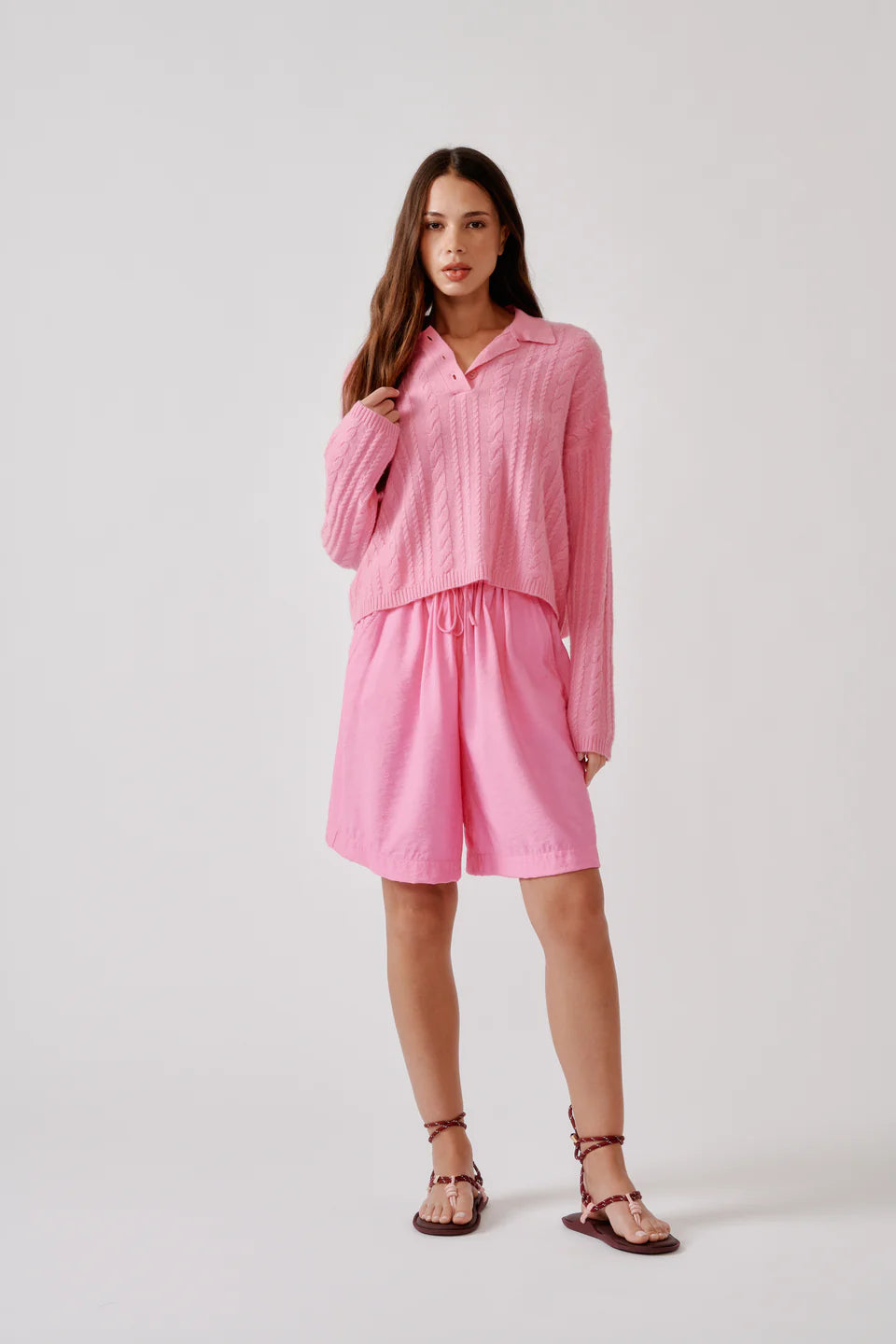 Relaxed long sleeve polo sweater in soft cashmere cable stitch with an open neckline.