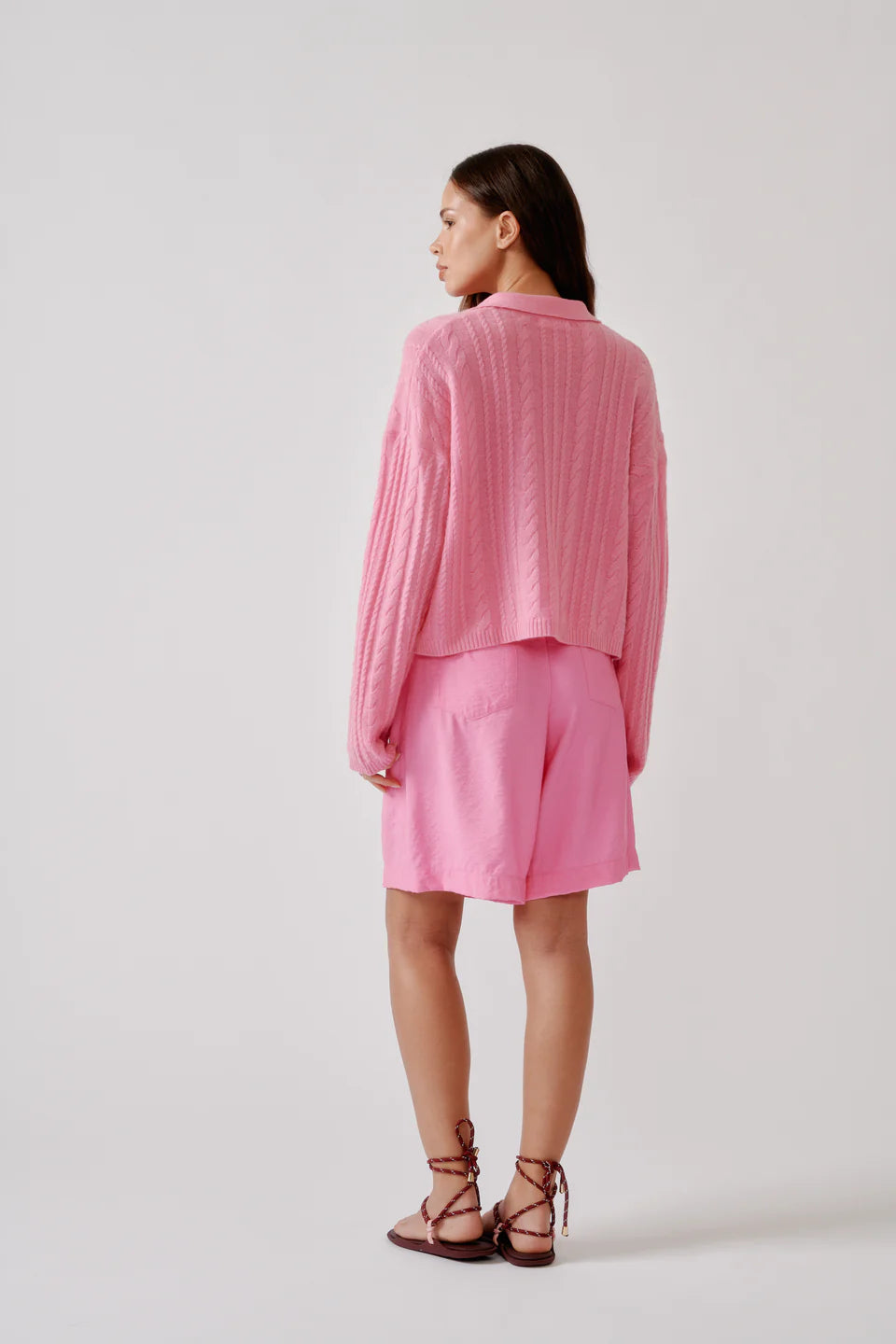 Relaxed long sleeve polo sweater in soft cashmere cable stitch with an open neckline.