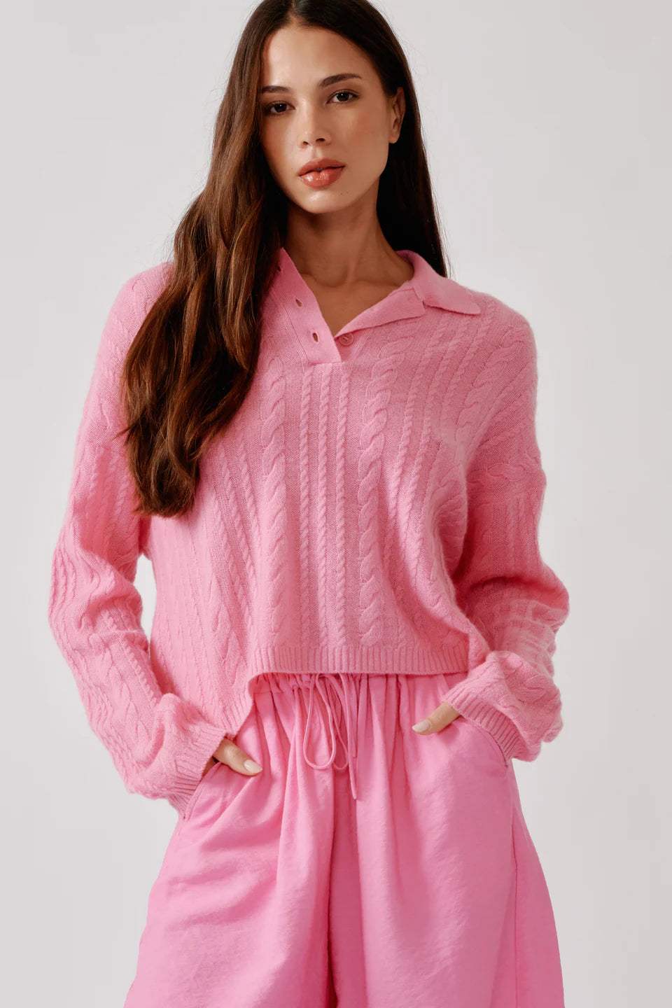 Relaxed long sleeve polo sweater in soft cashmere cable stitch with an open neckline.