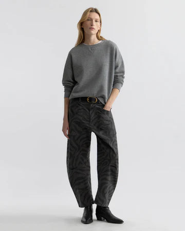 Woman wearing Nili Lotan Shon pant in Charcoal Zebra print and grey sweater