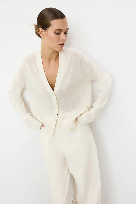 woman wearing ivory cashmere button down cardigan