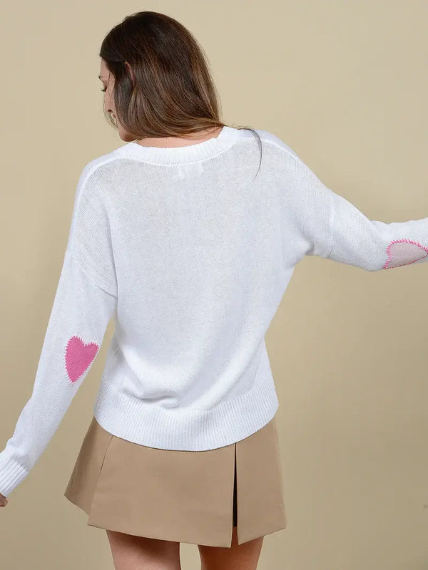 This V-neck pullover is meticulously crafted, featuring adorable heart elbow patches that add a touch of whimsy to a classic design.