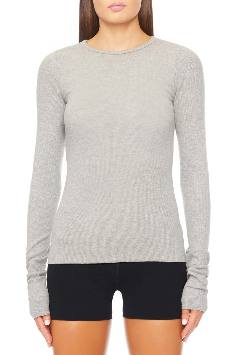 Made with luxurious ribbed cotton and modal blend, this top offers a flattering slim fit and full length, making it a versatile everyday essential. Stay comfortable and stylish with ÉTERNE.