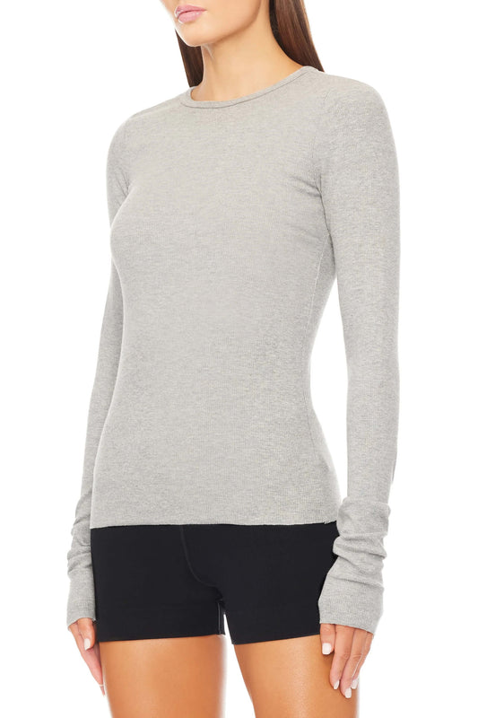 Made with luxurious ribbed cotton and modal blend, this top offers a flattering slim fit and full length, making it a versatile everyday essential. Stay comfortable and stylish with ÉTERNE.