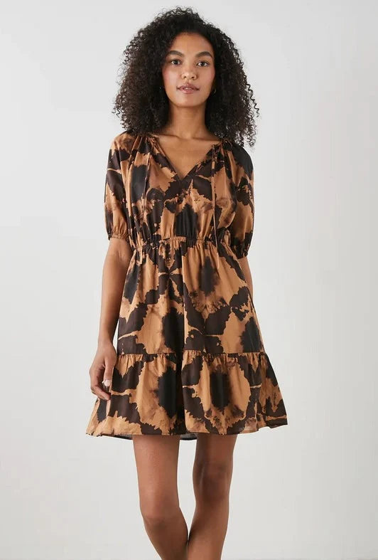 Woman wearing brown tone mini dress with puff sleeve