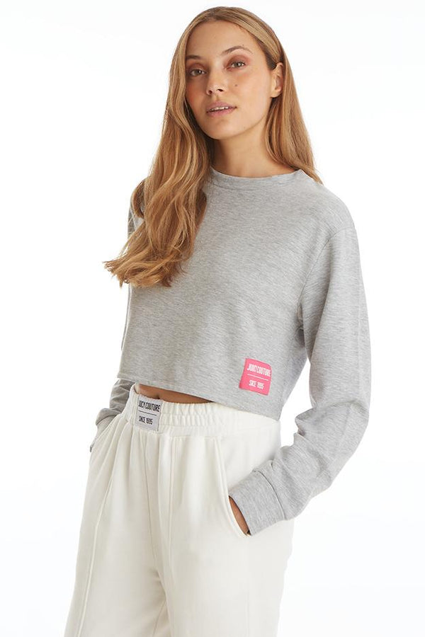 Front view of the Juicy Couture Boxy Pullover in Powder Heather on model showing off contrasting pink logo patch
