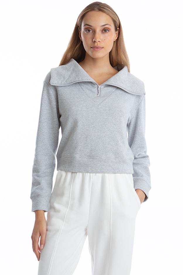 Front view of Juicy Couture High Collar Half Zip top in Grey on model with collar turned down and 1/2 zipper down